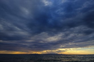 Thunderclouds at sunset on the beach