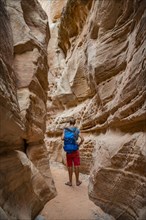 Young man standing in ravine of Slot Canyon