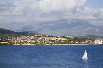 Catamaran on Mediterranean sea and town of Ajaccio