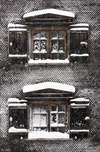 Snow-covered windows on old farmhouse