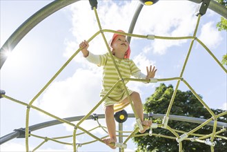 Toddler on climbing frame at a playground