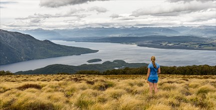 Female hiker looking at lake Te Anau and Southfiord