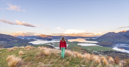 Hiker overlooking Lake Wanaka and mountains