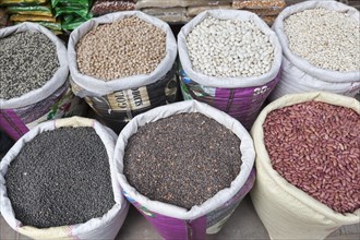 Assorted bean varieties for sale at a market