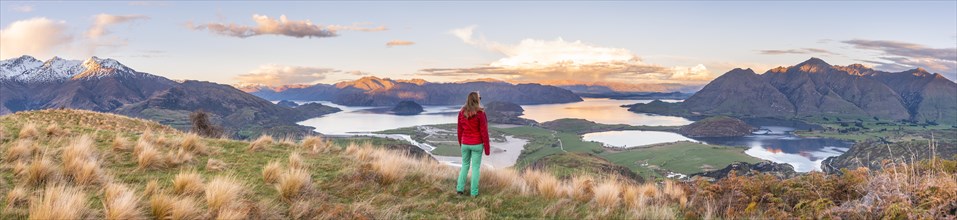 Hiker overlooking Lake Wanaka and mountains