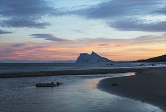 View of The Rock of Gibraltar and La Linea de la Concepcion as seen from the Mediterranean coast at sunset