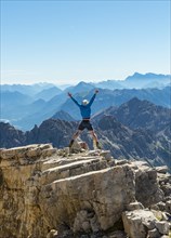 Hiker stretching arms in the air
