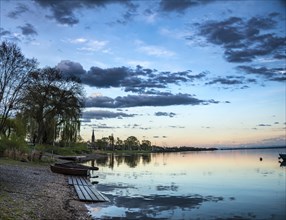 Rowboats by the lake at sunset