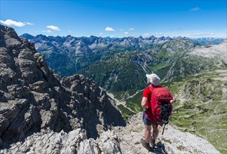 Walker overlooks mountains and Alps