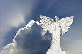 White Angel with blue sky and clouds