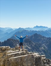 Hiker stretching arms in the air