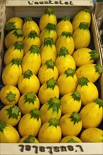 Vegetable crate with yellow eggplant at a market