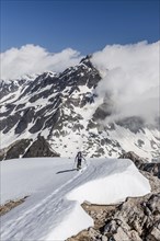 Ski tourer ascending the Hochweisse near Pfossental in Schnals