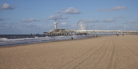 Pier with bungee jumping tower and Ferris wheel
