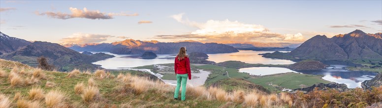 Hiker overlooking Lake Wanaka and mountains