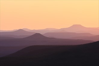 Staggered mountains at sunset