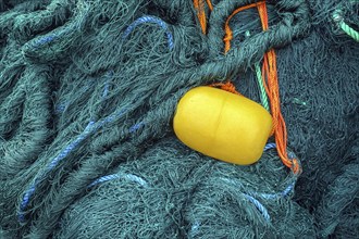 Green fishing net with yellow float