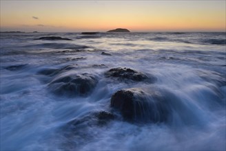 Waves washing around rocks in the ocean