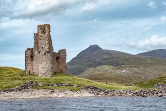 Castle ruin Ardvreck Castle on a peninsula by lake Loch Assynt