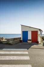 Garage by the sea painted in French national colours