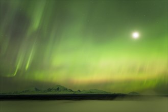 Aurora and the moon over the fog shrouded Copper River