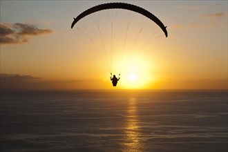 Paraglider at sunset over the Atlantic