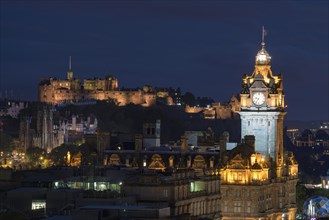 View of illuminated historic centre of Edinburgh with Balmoral Hotel tower and Edinburgh Castle
