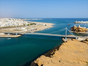 View of Sur seaport and blue lagoon with Khor Al Batah Suspension Bridge