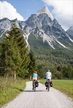Cyclist with mountain bikes