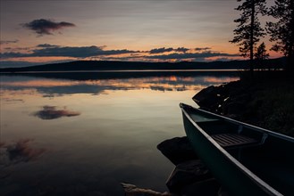 Canoe on shore at sunset