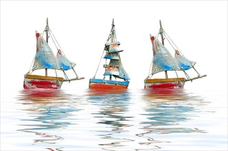 Three crafted sailboats