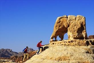 Hikers climb Elephant Rock outside of Petra
