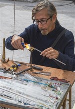 Man creating glass jewelry