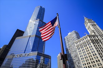 American flag in front of Trump Tower Chicago and Wrigley Building