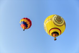 Two hot air balloons rising into the air