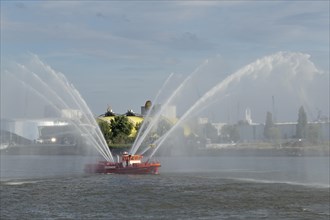 Fire-fighting boat with water fountains at the St. Pauli Piers