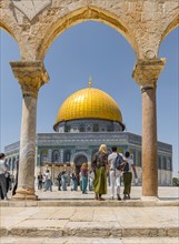 Tourists at the archway in front of the Dome of the Rock
