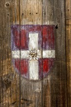 Coat of arms of Savoy on a wooden door