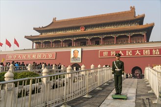 Guardsman in front of portrait of Mao Zedong