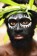 Korafe-Man with facial painting and headdress made of leaves