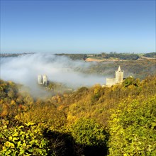 Castle ruins Saaleck and Rudelsburg in the autumn morning mist in the Saaletal valley