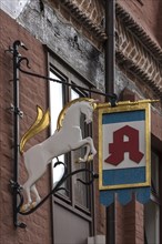 Hanging shop sign of the Unicorn Pharmacy