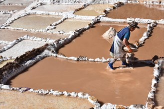 Woman works in terraces for salt extraction