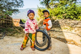 Two little boys with tires as toys