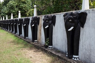 Elephant heads at entrance to Aluvihara Rock Temple
