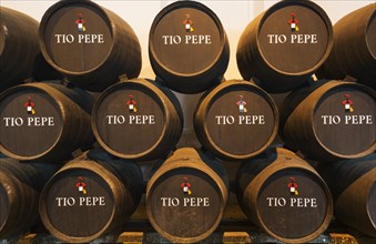 Stacked oak barrels with the famous Tio Pepe sherry