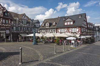 Market square with half-timbered houses and historic water pump