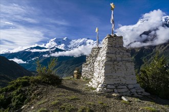 White chorten on a hill above Manang