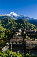View on the historical village with the mountains Annapurna South