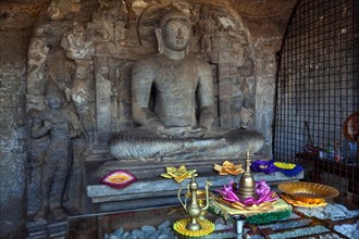 Buddha statue with offerings